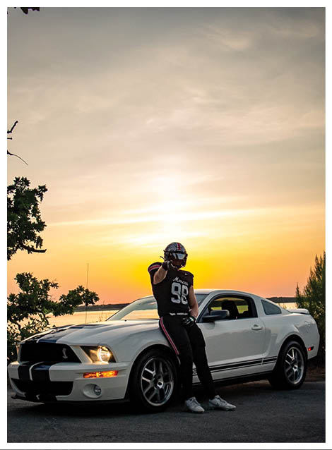 Two football players wearing black jerseys and holding hands. Description generated by AI