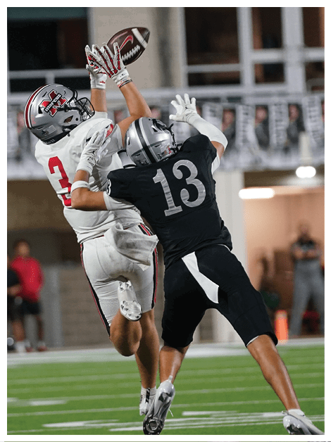 Two football players wearing black jerseys and holding hands. Description generated by AI