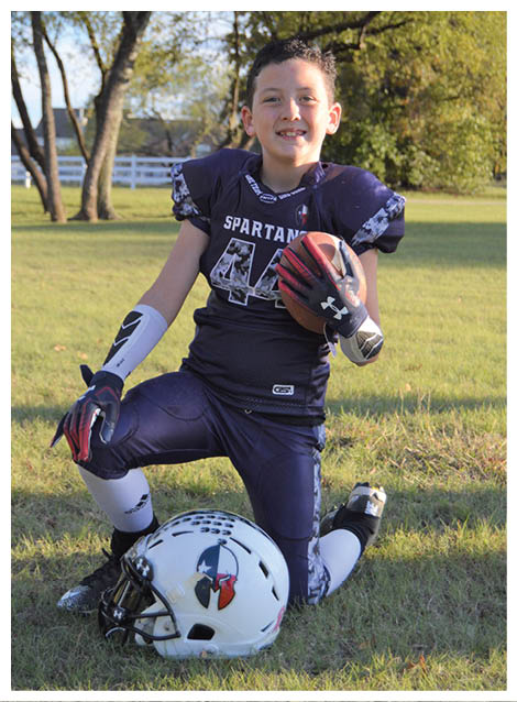Two football players wearing black jerseys and holding hands. Description generated by AI