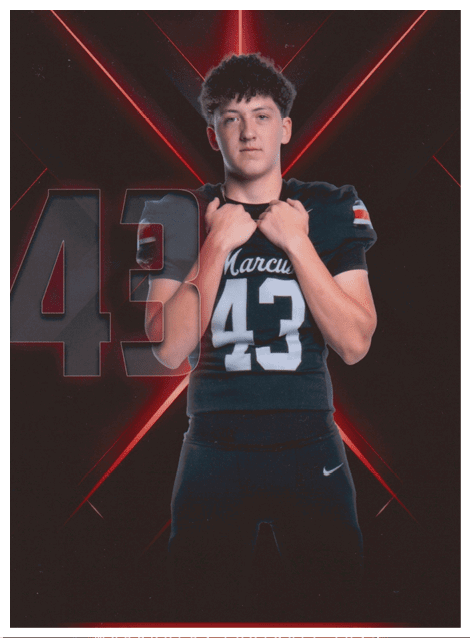 Two football players wearing black jerseys and holding hands. Description generated by AI