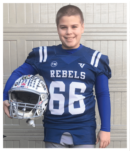 A person wearing a blue football jersey with the number 66 and the word Rebels is smiling while holding a white football helmet decorated with stickers. Description generated by AI