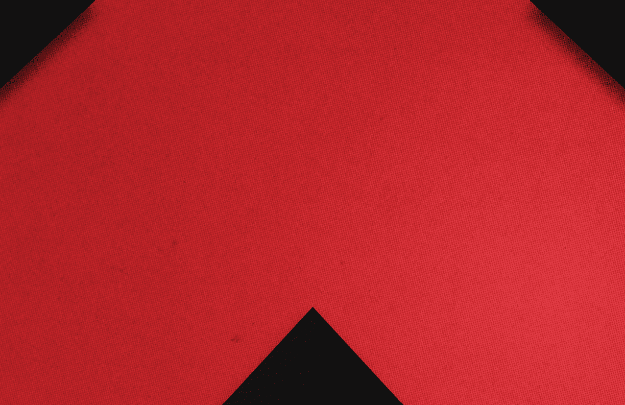 A red triangle on a black background. Description generated by AI