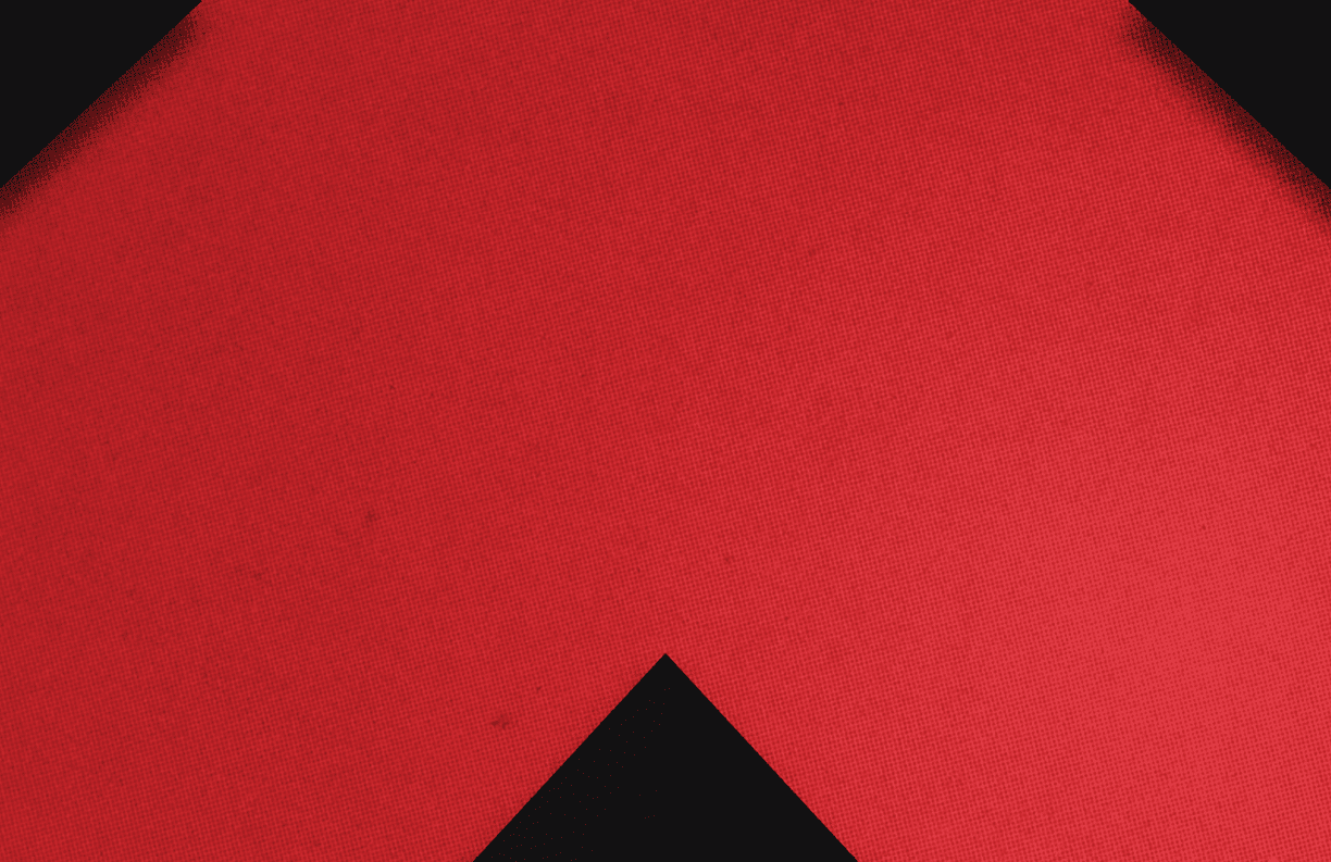 A red triangle on a black background. Description generated by AI