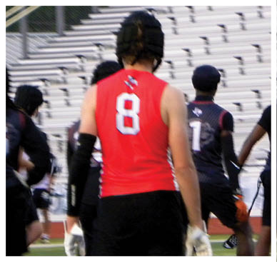 A football player wearing a blue and red jersey. Description generated by AI