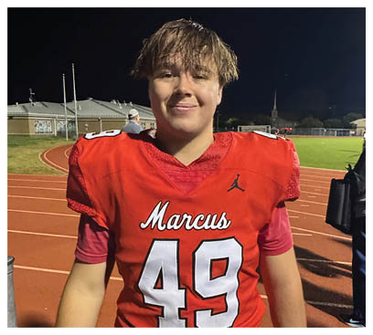 A football player wearing a blue and red jersey. Description generated by AI