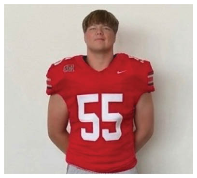 A football player wearing a blue and red jersey. Description generated by AI