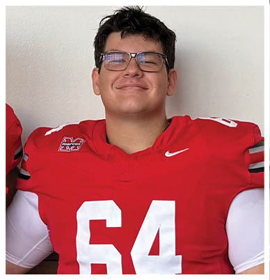 A football player wearing a blue and red jersey. Description generated by AI