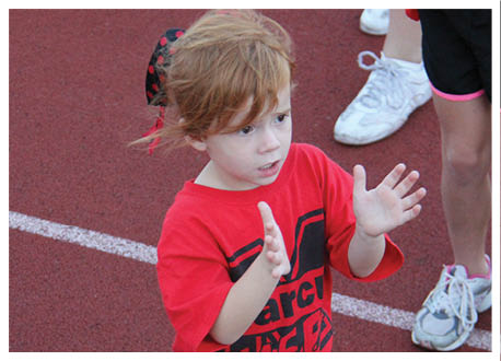 A football player wearing a blue and red jersey. Description generated by AI