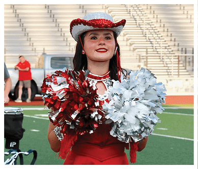A football player wearing a blue and red jersey. Description generated by AI