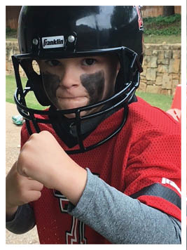 A football player wearing a blue and red jersey. Description generated by AI