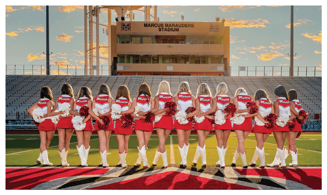 A group of cheerleaders pose for a photo in front of a stadium. AI generated content