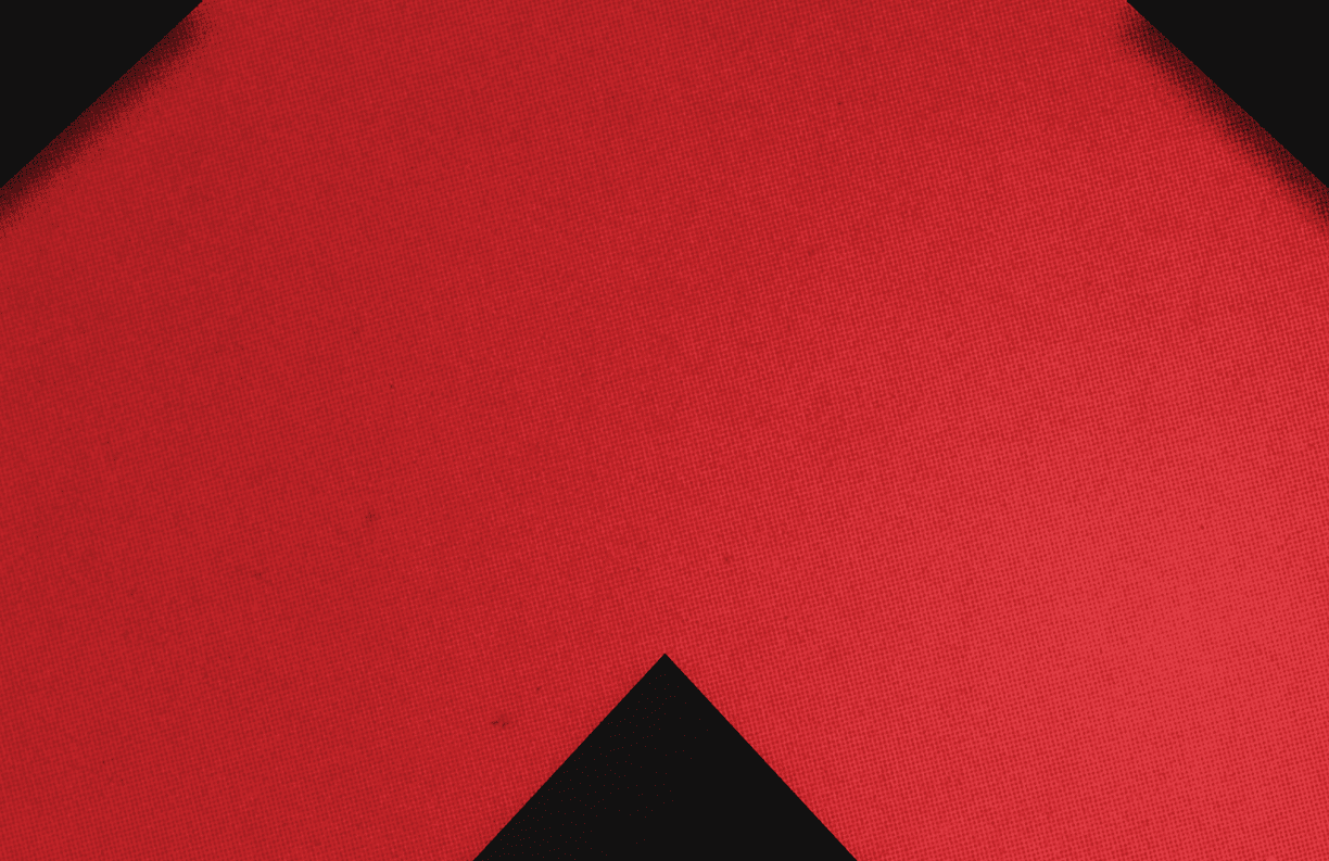 A red triangle on a black background. Description generated by AI