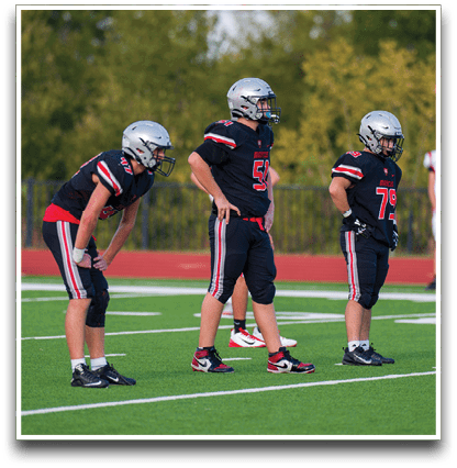 Three football players are standing on the field, one of them is smiling and wearing a black jersey with the number 55. AI generated content