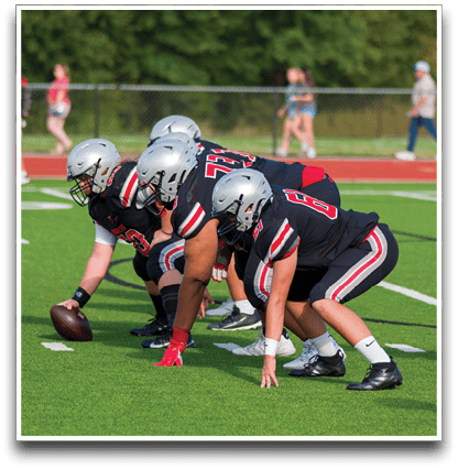 Three football players are standing on the field, one of them is smiling and wearing a black jersey with the number 55. AI generated content