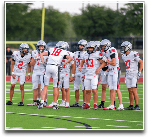 Three football players are standing on the field, one of them is smiling and wearing a black jersey with the number 55. AI generated content