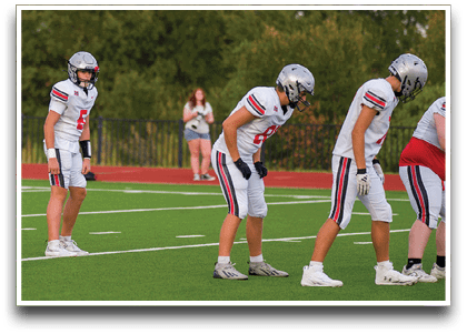 Three football players are standing on the field, one of them is smiling and wearing a black jersey with the number 55. AI generated content