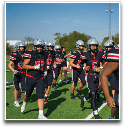Three football players are standing on the field, one of them is smiling and wearing a black jersey with the number 55. AI generated content