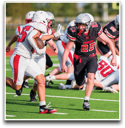 Three football players are standing on the field, one of them is smiling and wearing a black jersey with the number 55. AI generated content