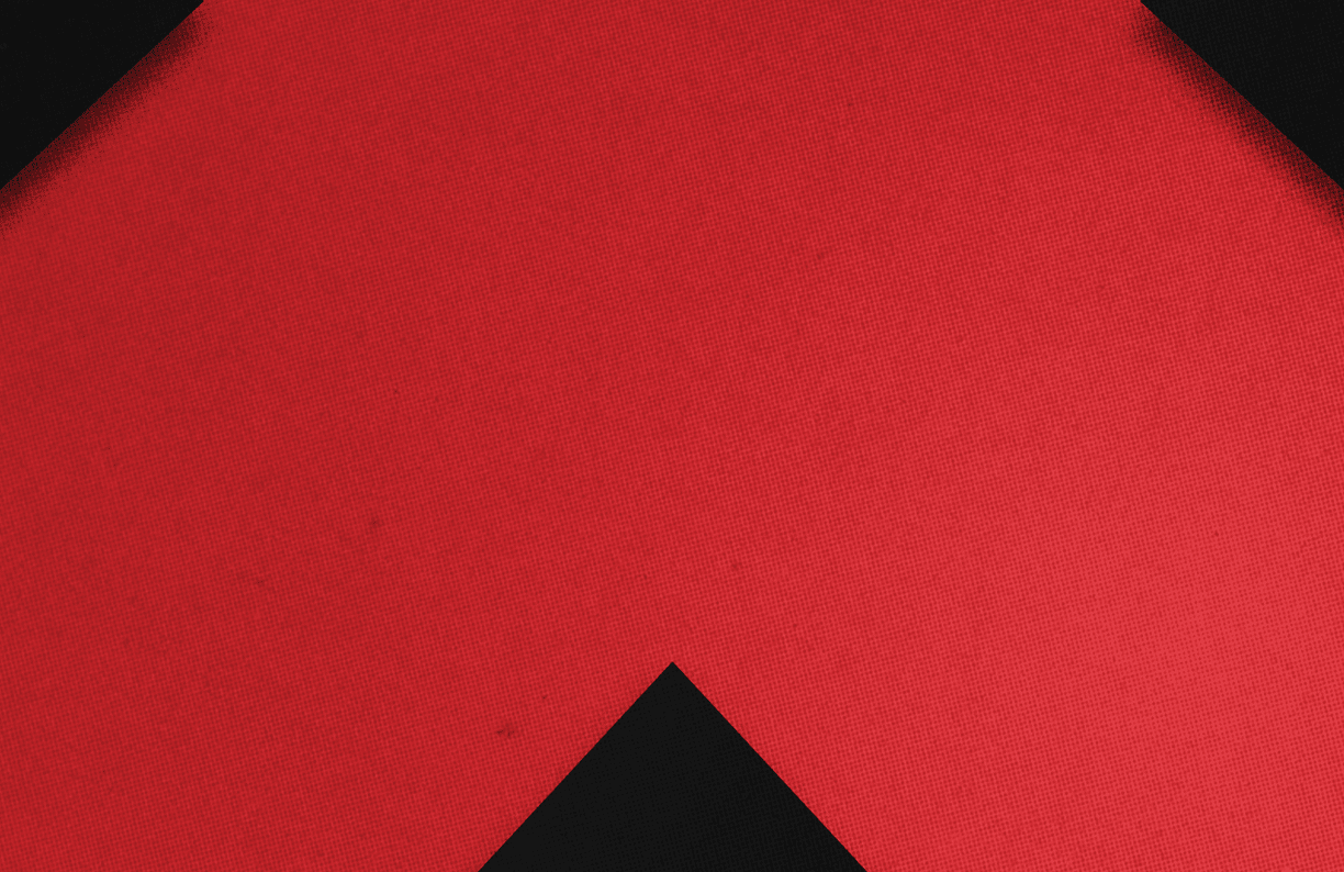 A red triangle on a black background. Description generated by AI