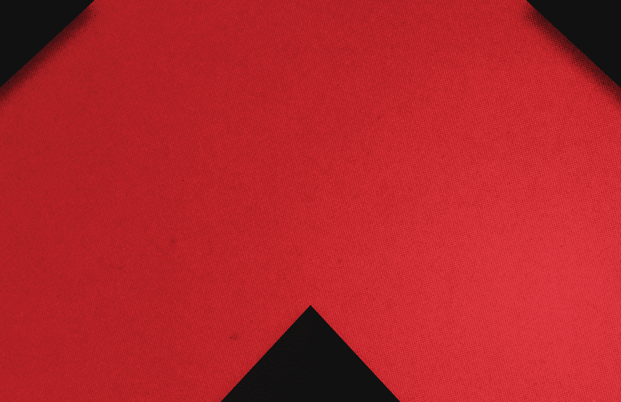 A red triangle on a black background. Description generated by AI