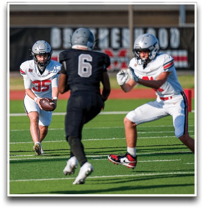 Three football players are standing on the field, one of them is smiling and wearing a black jersey with the number 55. AI generated content