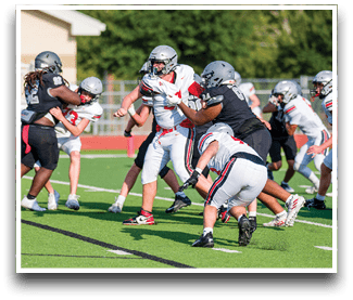 Three football players are standing on the field, one of them is smiling and wearing a black jersey with the number 55. AI generated content