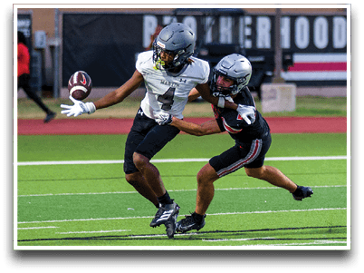 Three football players are standing on the field, one of them is smiling and wearing a black jersey with the number 55. AI generated content