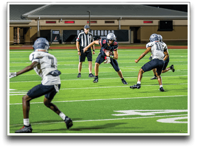 Three football players are standing on the field, one of them is smiling and wearing a black jersey with the number 55. AI generated content