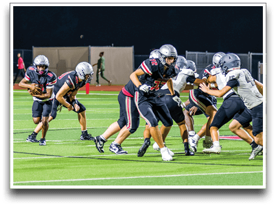 Three football players are standing on the field, one of them is smiling and wearing a black jersey with the number 55. AI generated content