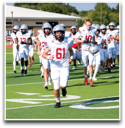 Three football players are standing on the field, one of them is smiling and wearing a black jersey with the number 55. AI generated content