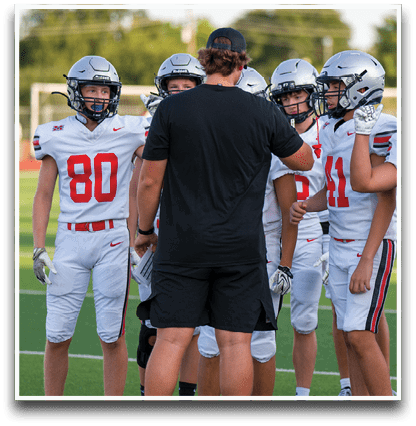 Three football players are standing on the field, one of them is smiling and wearing a black jersey with the number 55. AI generated content