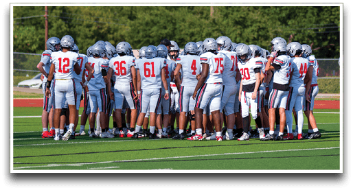 Three football players are standing on the field, one of them is smiling and wearing a black jersey with the number 55. AI generated content