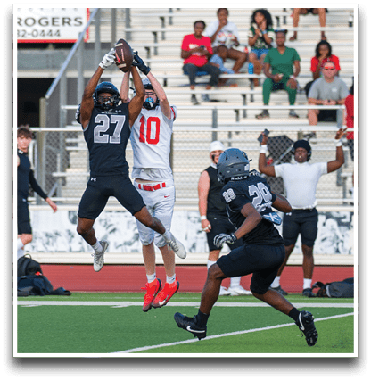 Three football players are standing on the field, one of them is smiling and wearing a black jersey with the number 55. AI generated content