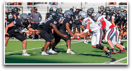 Three football players are standing on the field, one of them is smiling and wearing a black jersey with the number 55. AI generated content