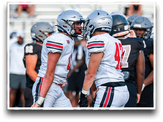 Three football players are standing on the field, one of them is smiling and wearing a black jersey with the number 55. AI generated content