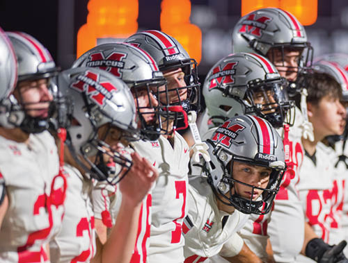 Three football players are standing on the field, one of them is smiling and wearing a black jersey with the number 55. AI generated content