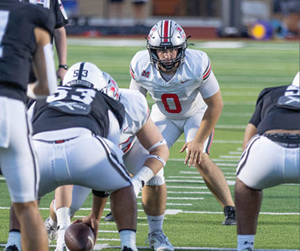 Three football players are standing on the field, one of them is smiling and wearing a black jersey with the number 55. AI generated content