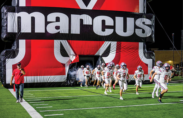 Three football players are standing on the field, one of them is smiling and wearing a black jersey with the number 55. AI generated content