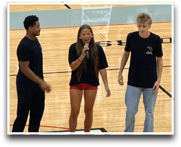 Three football players are standing on the field, one of them is smiling and wearing a black jersey with the number 55. AI generated content