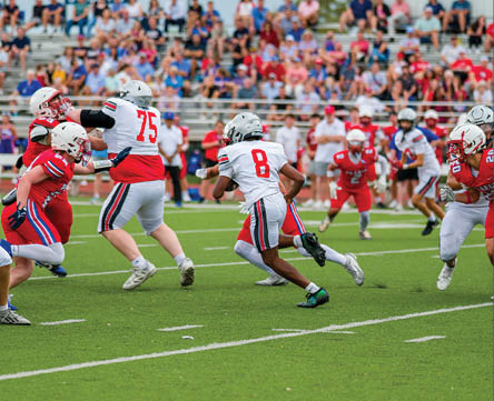 Three football players are standing on the field, one of them is smiling and wearing a black jersey with the number 55. AI generated content