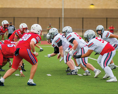 Three football players are standing on the field, one of them is smiling and wearing a black jersey with the number 55. AI generated content