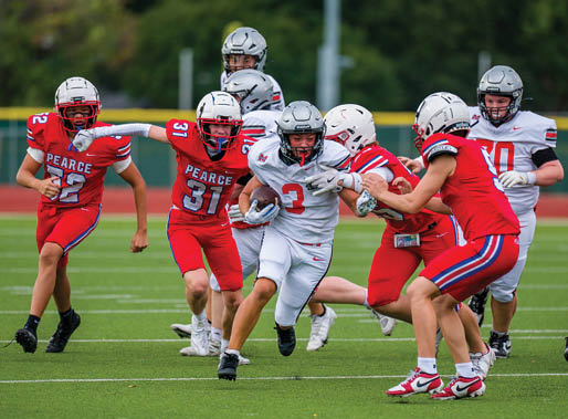 Three football players are standing on the field, one of them is smiling and wearing a black jersey with the number 55. AI generated content