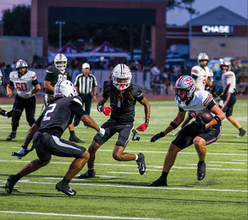 Three football players are standing on the field, one of them is smiling and wearing a black jersey with the number 55. AI generated content