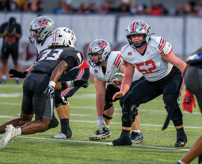Three football players are standing on the field, one of them is smiling and wearing a black jersey with the number 55. AI generated content