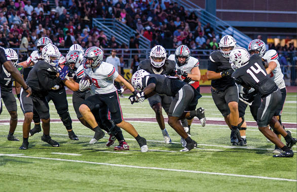 Three football players are standing on the field, one of them is smiling and wearing a black jersey with the number 55. AI generated content