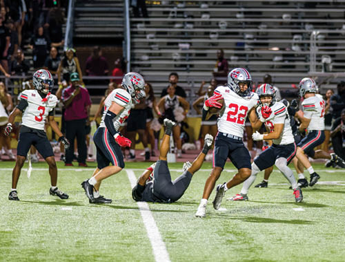 Three football players are standing on the field, one of them is smiling and wearing a black jersey with the number 55. AI generated content