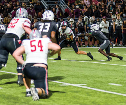Three football players are standing on the field, one of them is smiling and wearing a black jersey with the number 55. AI generated content