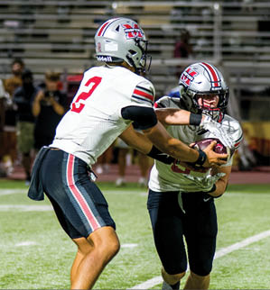 Three football players are standing on the field, one of them is smiling and wearing a black jersey with the number 55. AI generated content