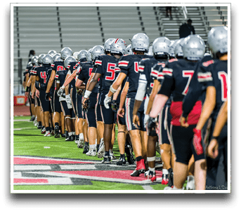 Three football players are standing on the field, one of them is smiling and wearing a black jersey with the number 55. AI generated content