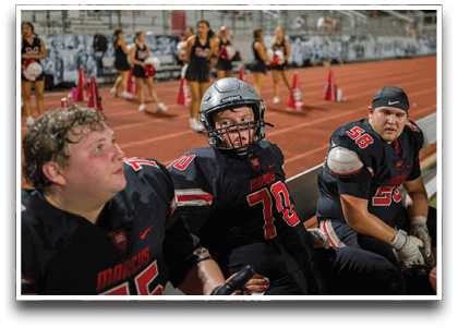 Three football players are standing on the field, one of them is smiling and wearing a black jersey with the number 55. AI generated content